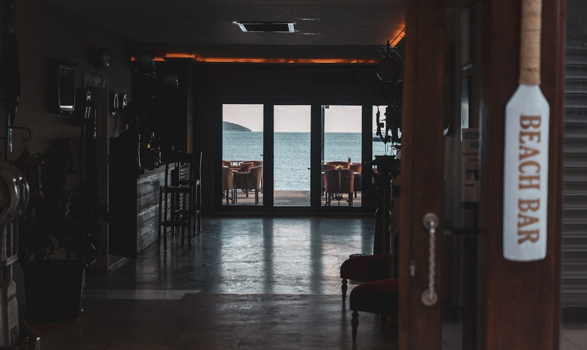 a hallway leading to a beach side restaurant