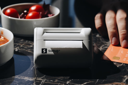 A person putting a credit card into a machine