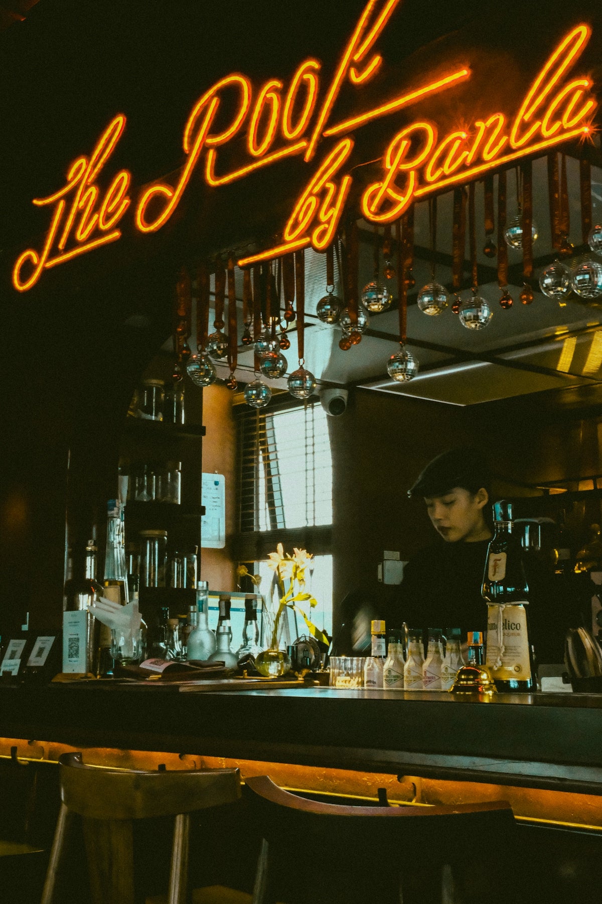 A bar that has a neon sign above it