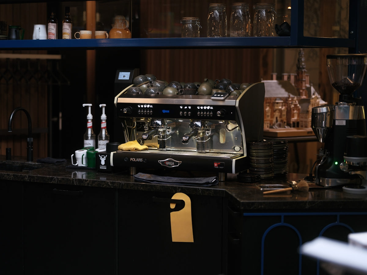 Espresso machine on a cafe counter with syrups