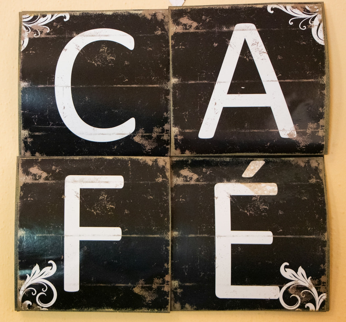 Four rustic signs spelling out cafe